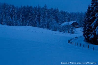Mountain hut with snow in the evening