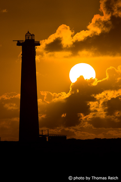 Silhouette lighthouse in front of sunset