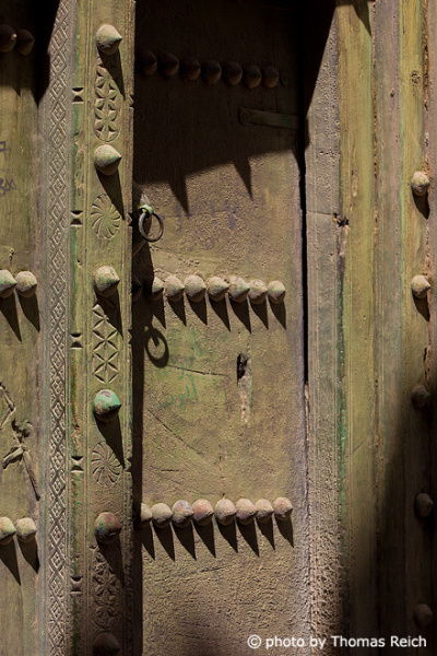 Carved wooden green door, Oman