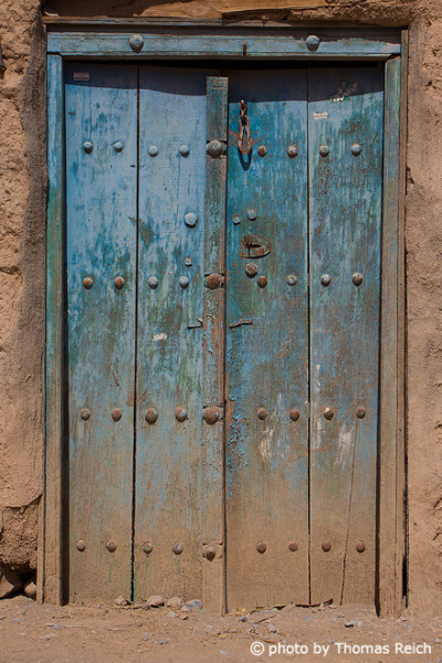 Carved wooden blue door, Oman