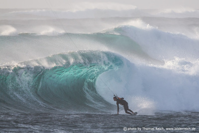 Kite surfer in big ocean waves
