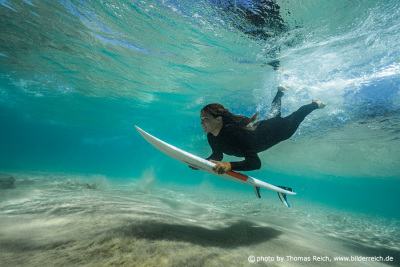 Surfer woman duck dive