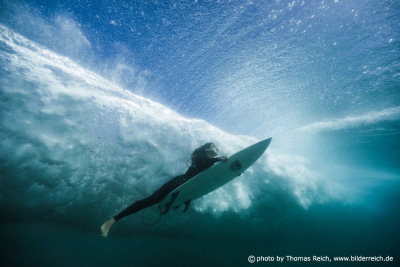 Surfer under wave