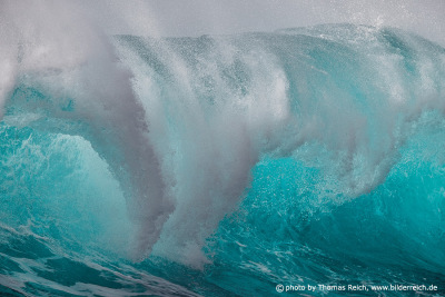 Turquoise wave breaking