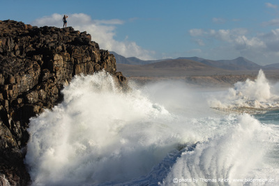 Woman cliff stormy ocean