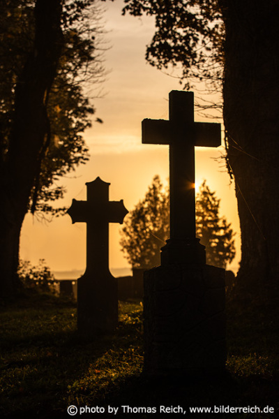 Gravestone crosses sunset
