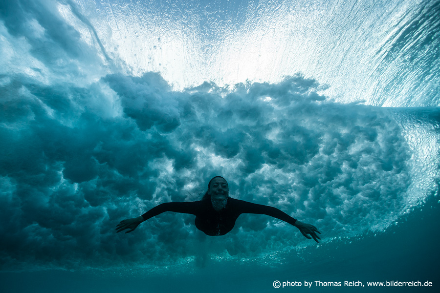 Girl diving with big wave